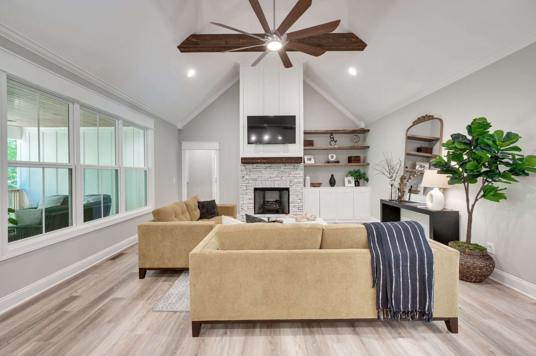 545 Delacy Drive Fairview, TN 37062 - Photo 18 of 40 a living room with furniture a fireplace and a potted plant