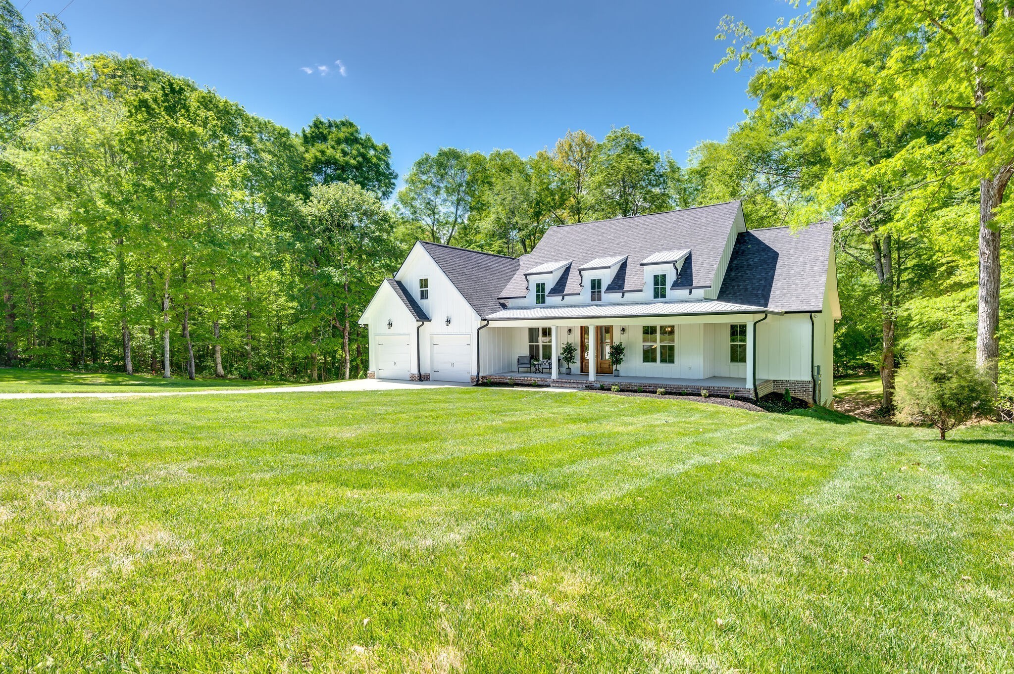 545 Delacy Drive Fairview, TN 37062 - Photo 3 of 40 a front view of a house with a garden
