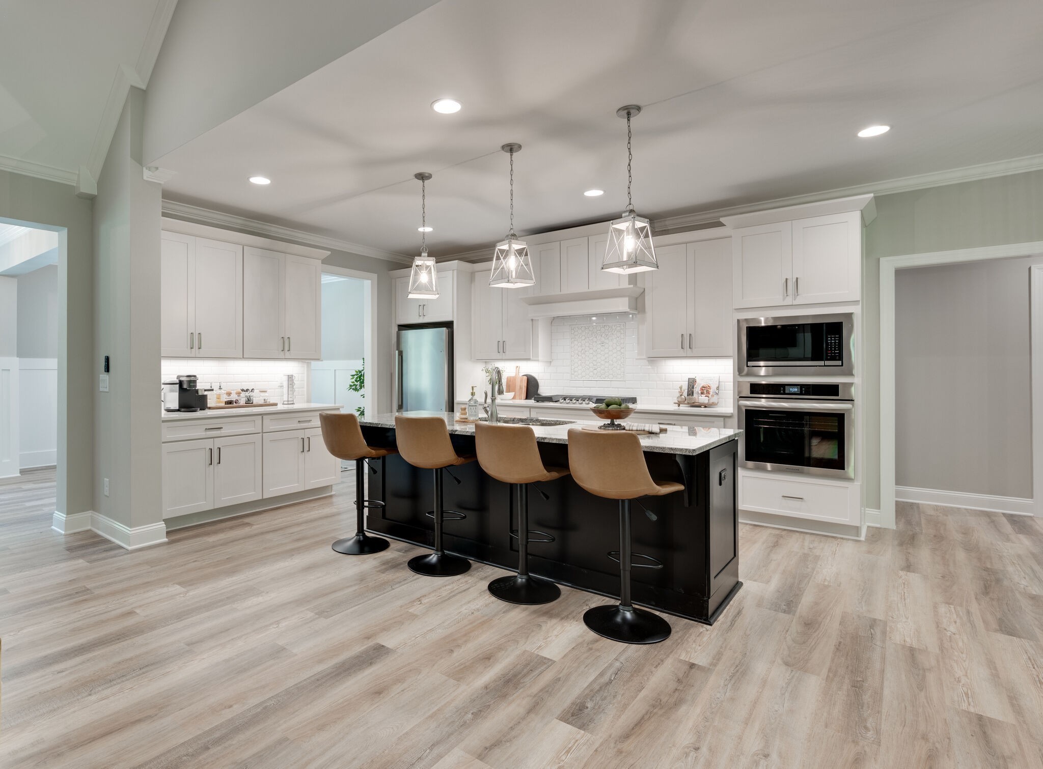 545 Delacy Drive Fairview, TN 37062 - Photo 9 of 40 a kitchen with stainless steel appliances kitchen island granite countertop a table chairs and a refrigerator