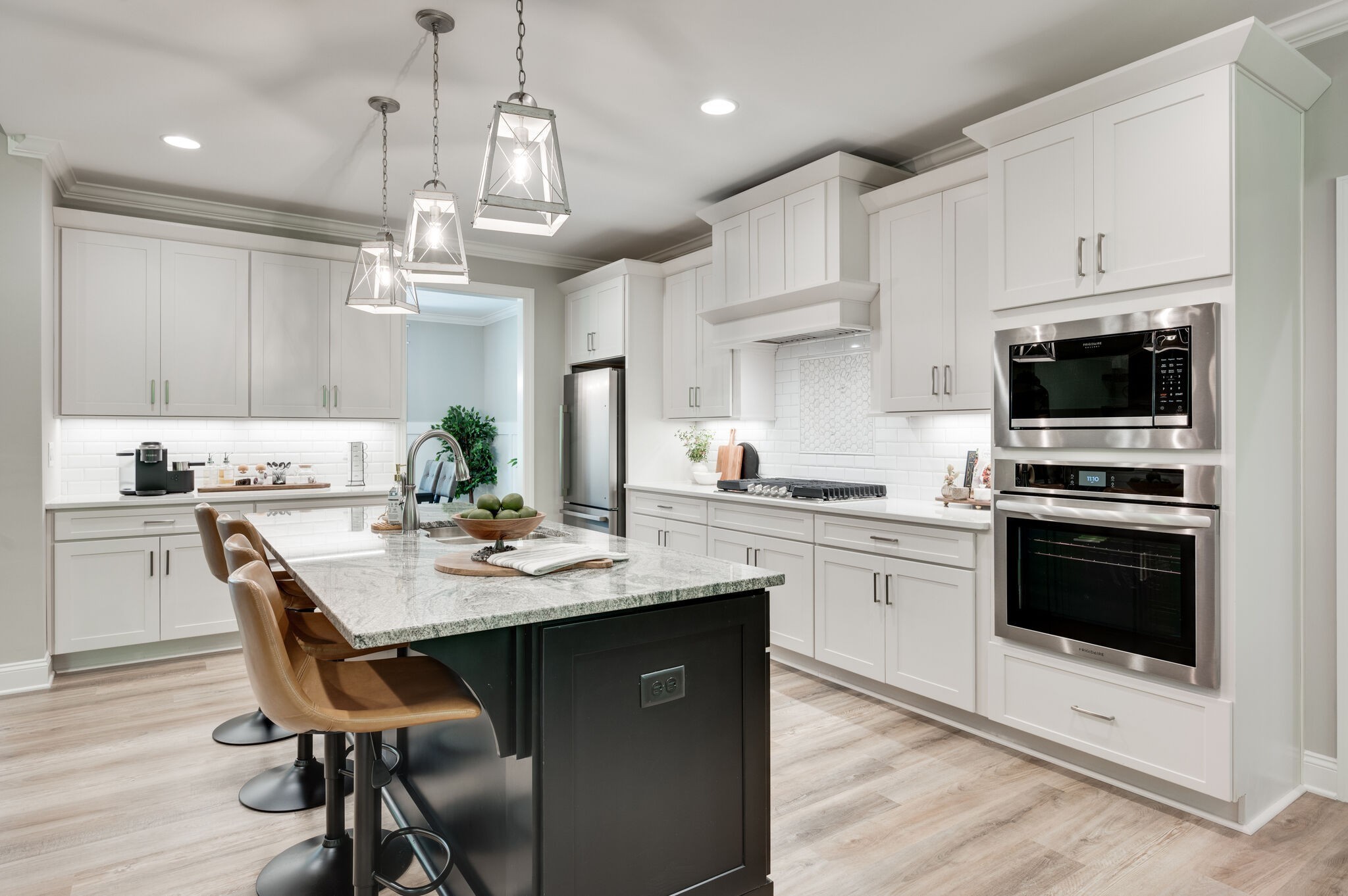 545 Delacy Drive Fairview, TN 37062 - Photo 10 of 40 a kitchen with kitchen island granite countertop a sink cabinets and wooden floor