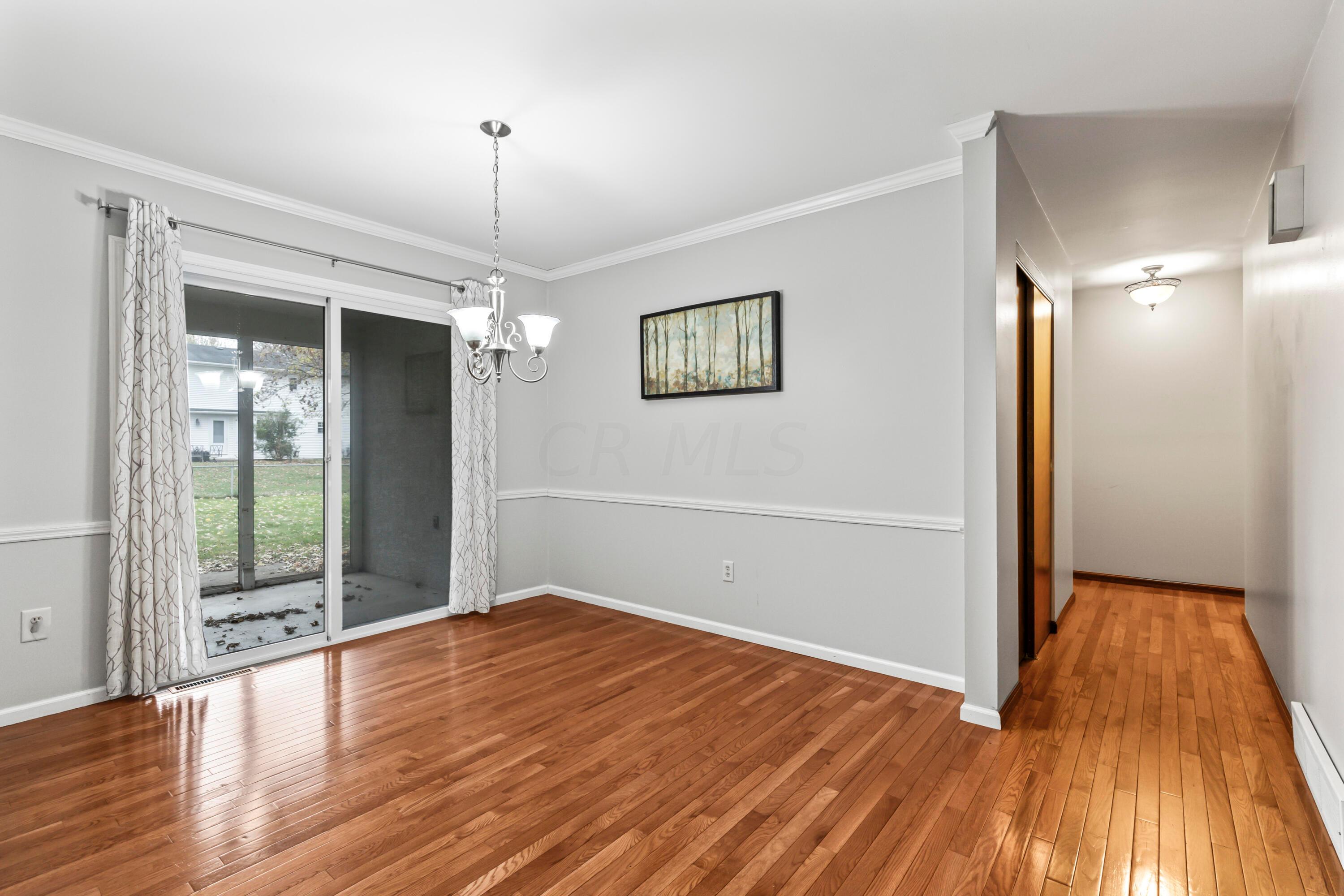 7020 Rieber Street Columbus, OH 43085 - Photo 10 of 40 • New hardwood flooring ~ 2012 • Grey painted walls • Crown molding • New chandelier ~ 2012 • Sliding doors to screened porch • Drapes are negotiable