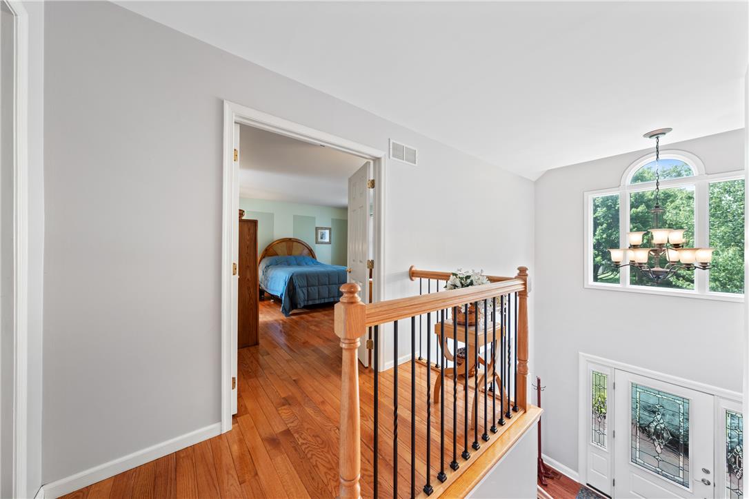 4568 Greenfield Road Bethlehem, PA 18017 - Photo 35 of 59 Hardwood flooring extends throughout the upper hallway, guiding to a spacious bedroom.