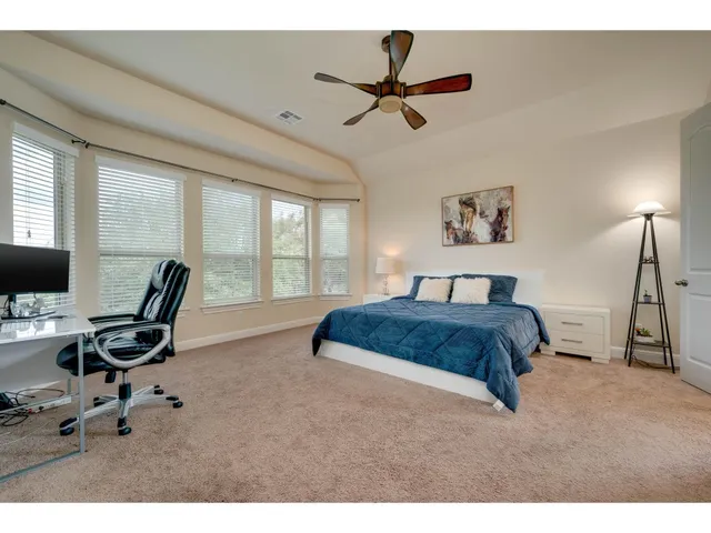 a bedroom with a bed a desk and chair