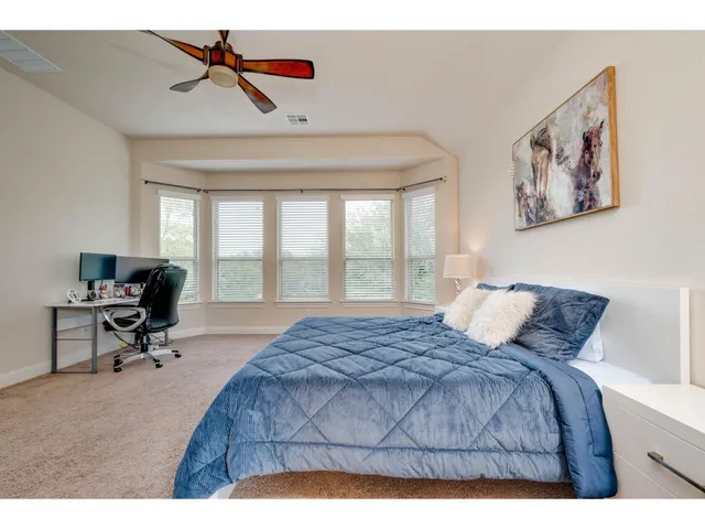 a bedroom with a bed and a desk