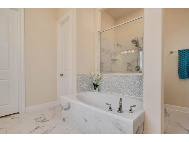 a bathroom with a tub and shower