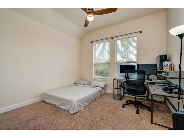 a bedroom with a bed and a desk
