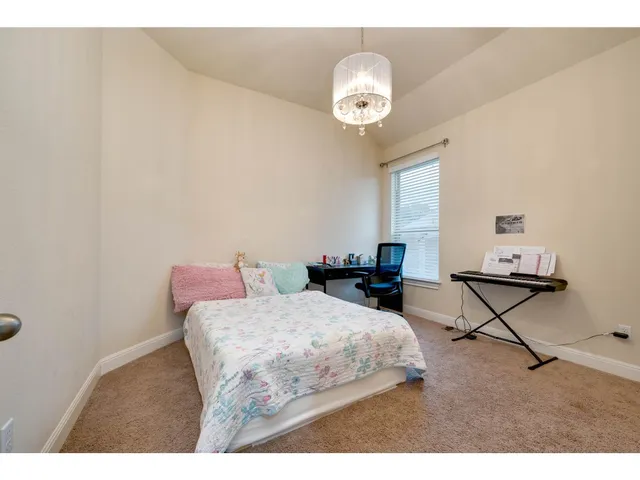 a bedroom with a bed a table and chair