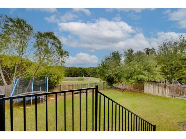 a view of a house with a big yard and a large tree