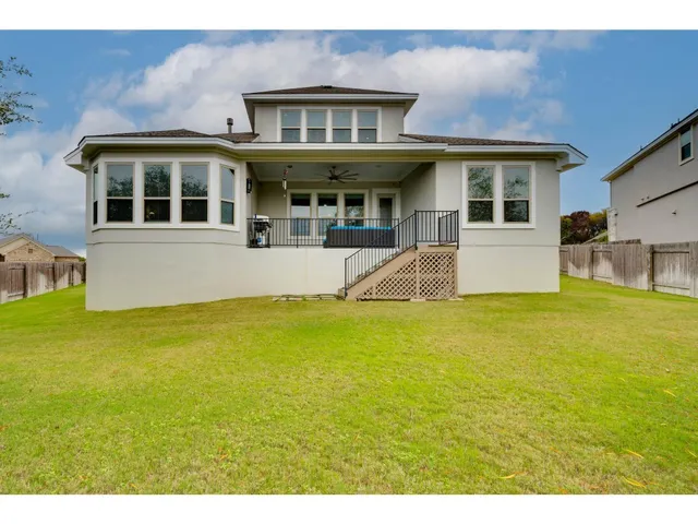 a backyard of a house with table and chairs