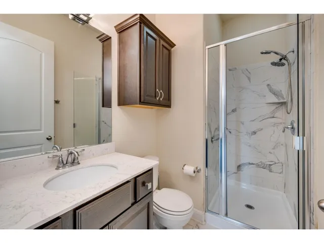 a bathroom with a sink toilet a shower and a mirror