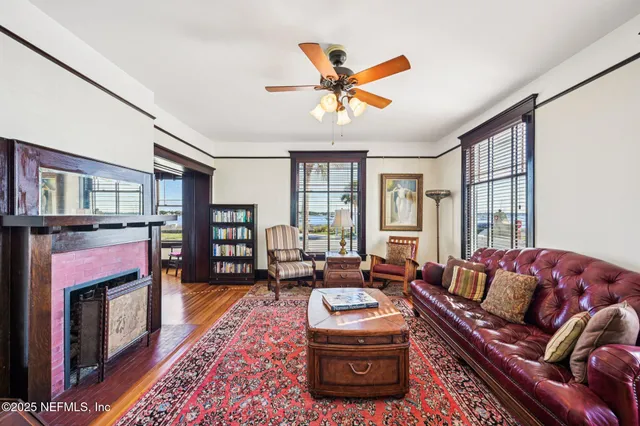 a dining room with furniture a flat screen tv and a floor to ceiling window
