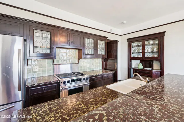 a view of a livingroom with furniture and floor to ceiling window