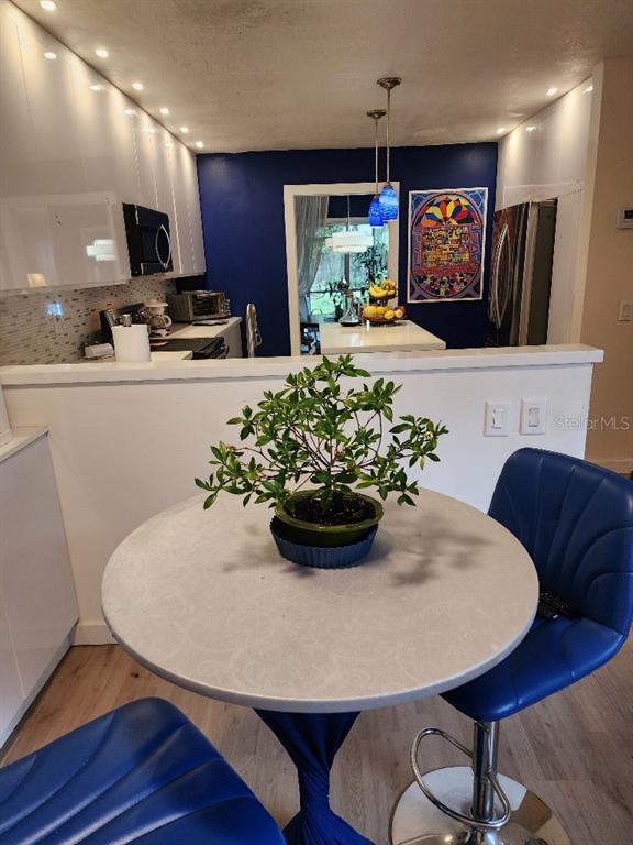 610 Chestnut Oak Circle, Unit 110 Altamonte Springs, FL 32701 - Photo 7 of 15 a view of a dining room with furniture and wooden floor