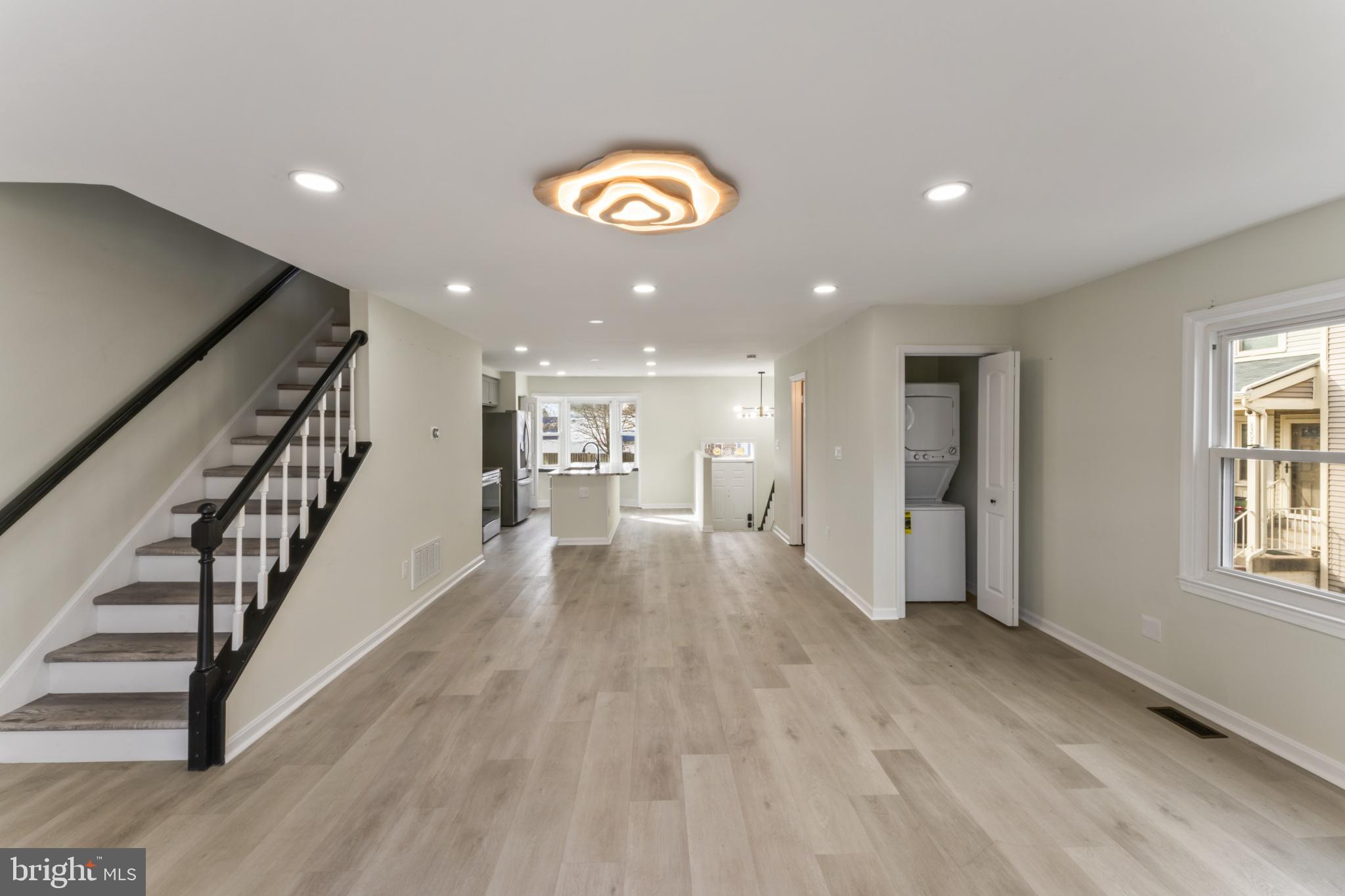 8213 Roxbury Drive Alexandria, VA 22309 - Photo 15 of 32 a view of a room with wooden floor staircase and a kitchen