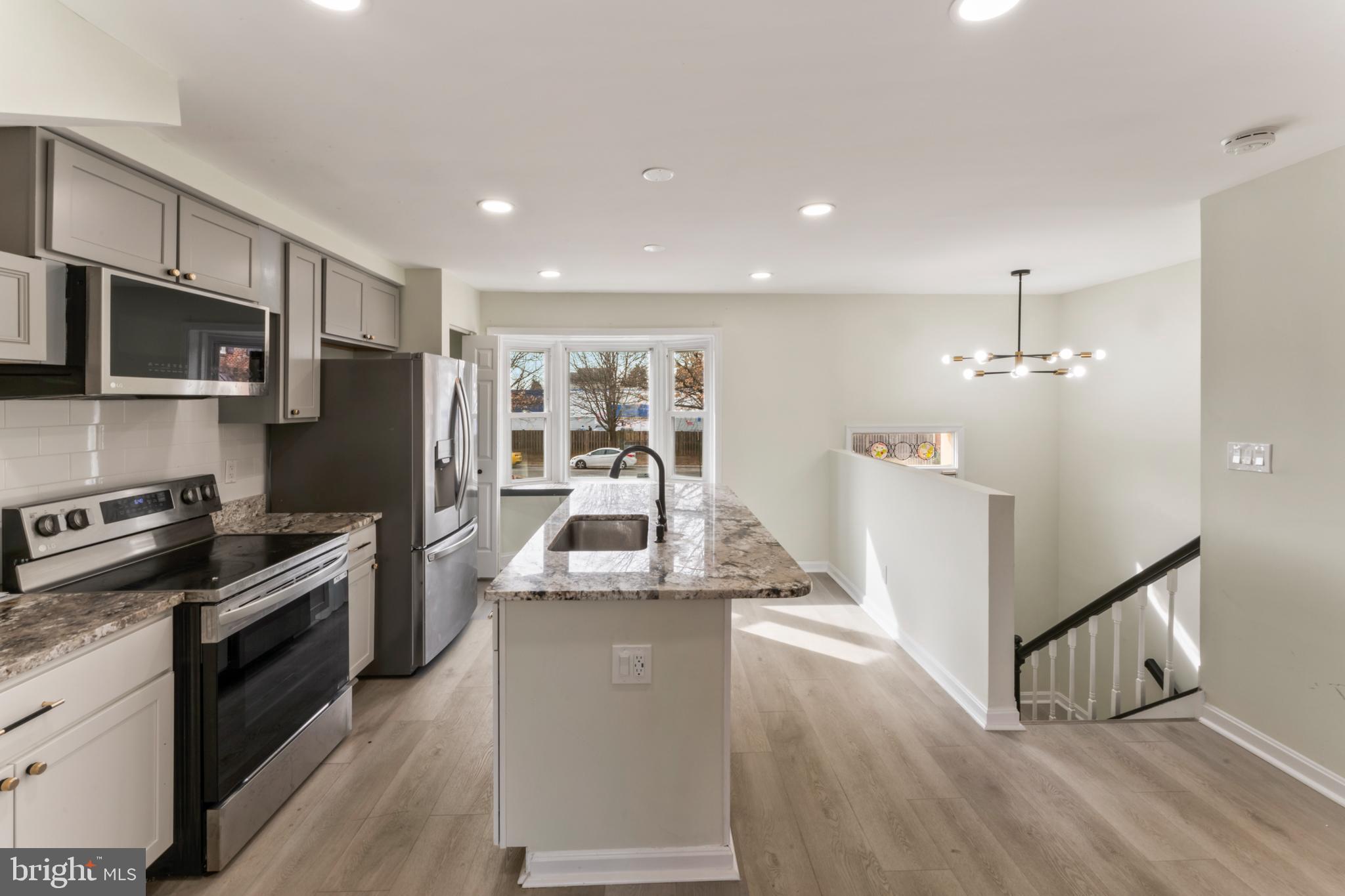 8213 Roxbury Drive Alexandria, VA 22309 - Photo 16 of 32 a kitchen with stainless steel appliances granite countertop a refrigerator a stove top oven a sink and dishwasher