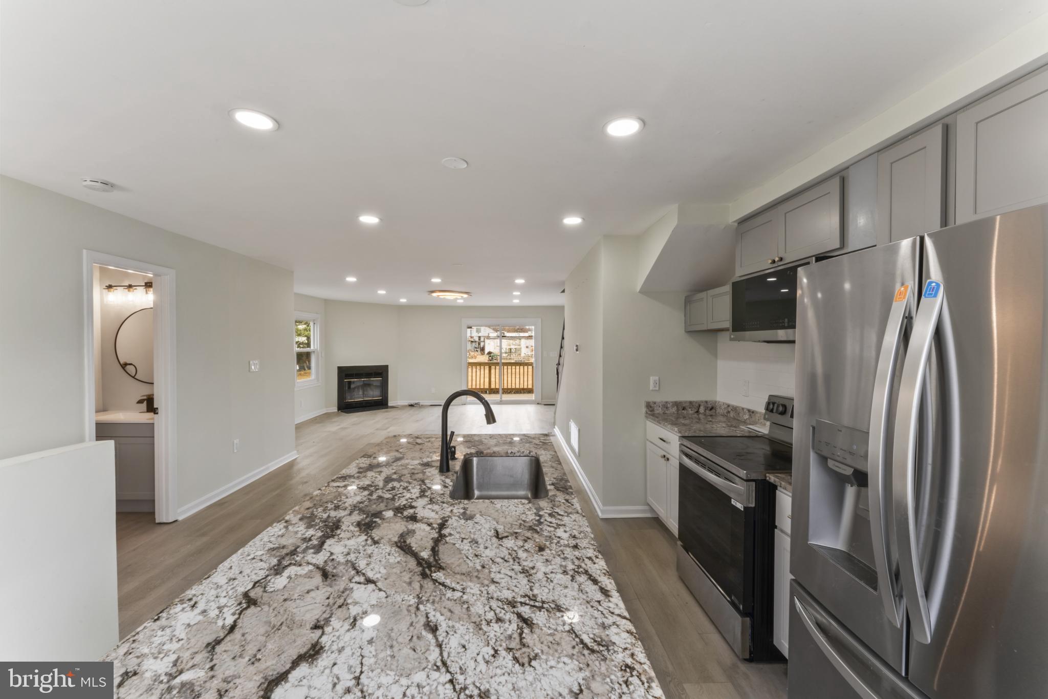 8213 Roxbury Drive Alexandria, VA 22309 - Photo 18 of 32 a kitchen with stainless steel appliances granite countertop a refrigerator and a stove