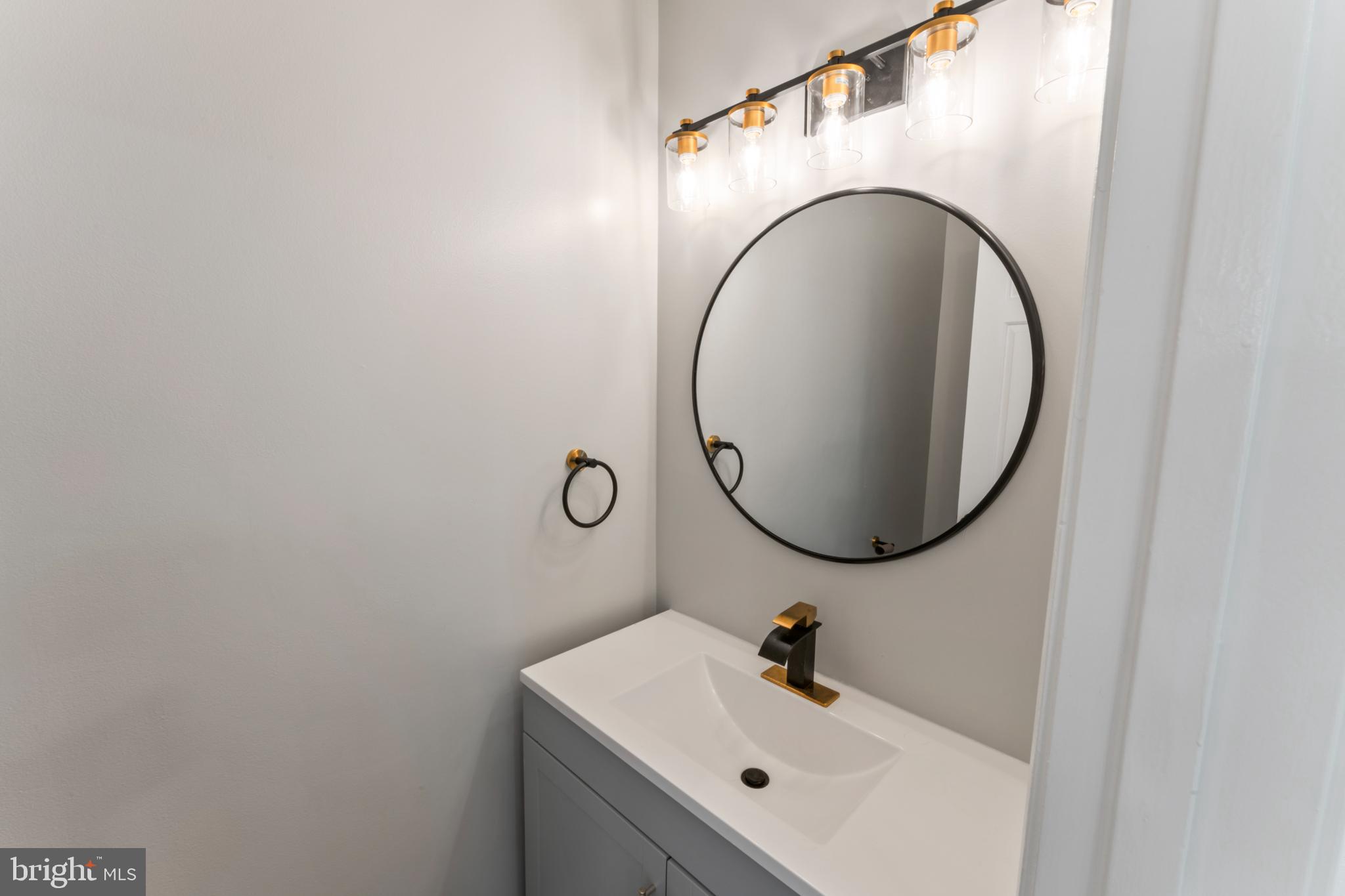 8213 Roxbury Drive Alexandria, VA 22309 - Photo 20 of 32 a bathroom with a sink and a mirror