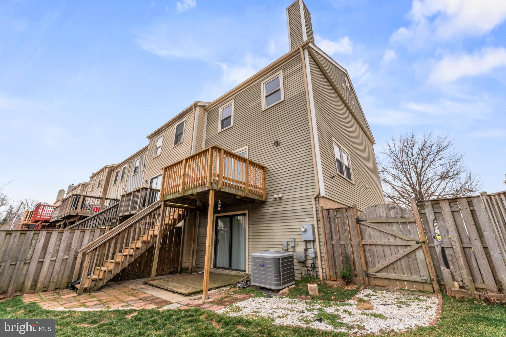 8213 Roxbury Drive Alexandria, VA 22309 - Photo 22 of 32 a view of a house with a small yard and wooden fence