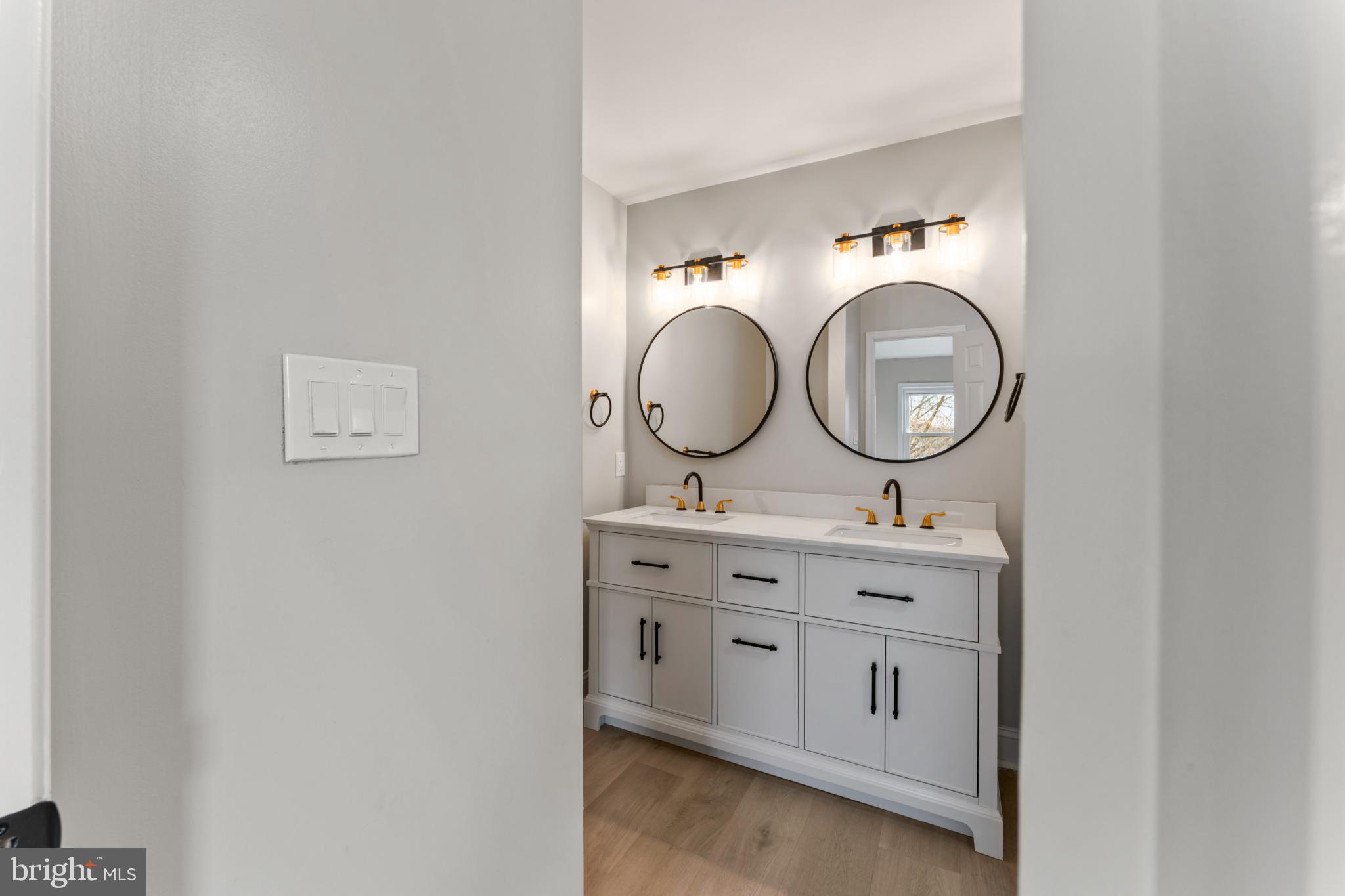 8213 Roxbury Drive Alexandria, VA 22309 - Photo 25 of 32 a bathroom with a sink and a mirror