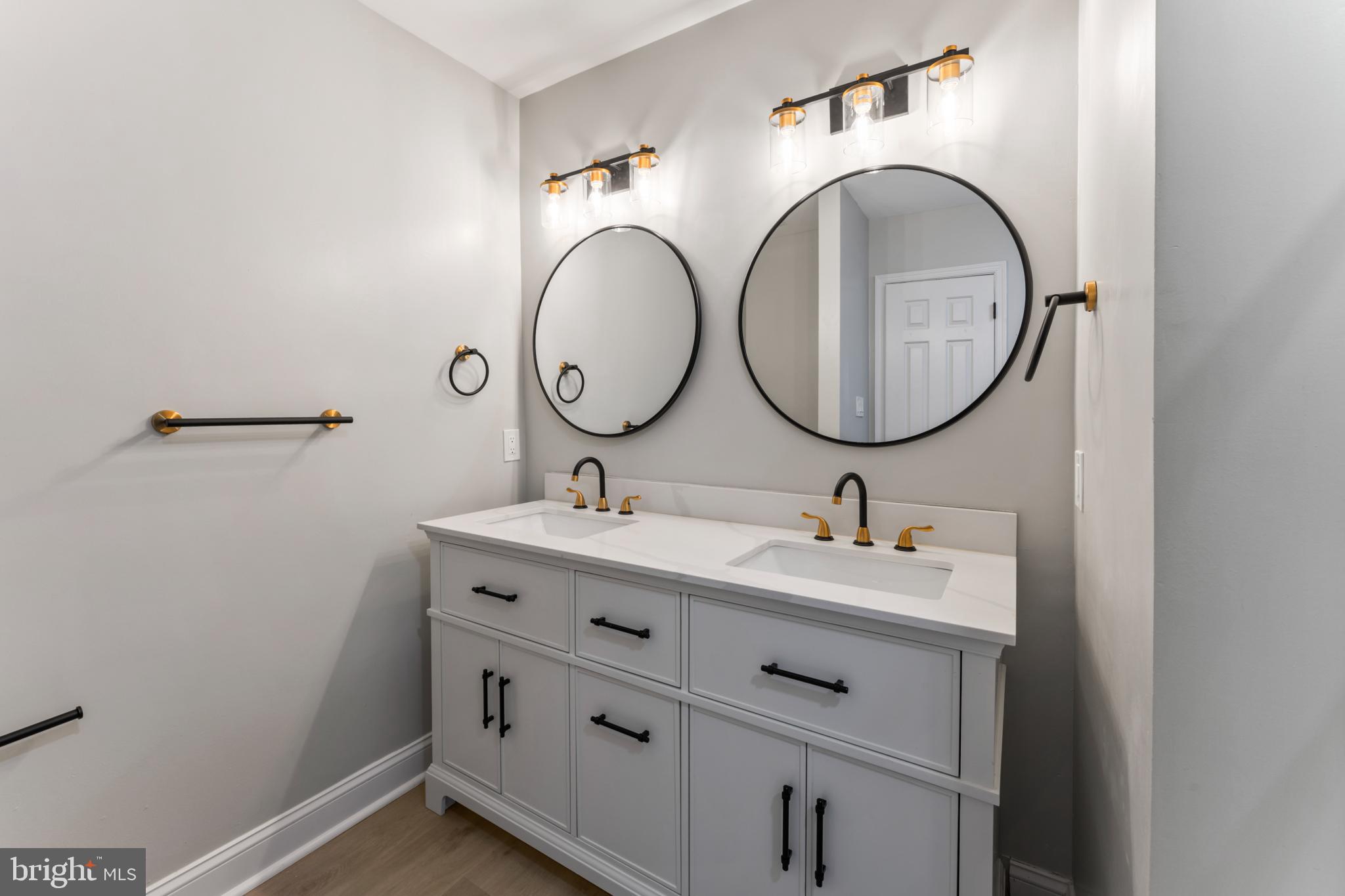 8213 Roxbury Drive Alexandria, VA 22309 - Photo 27 of 32 a bathroom with a sink and a mirror