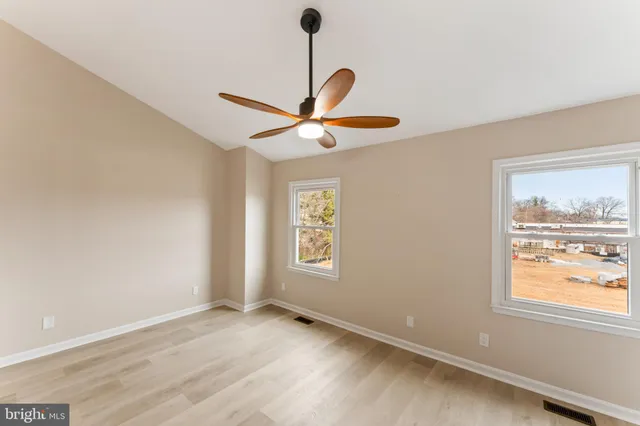 a view of a chandelier fan and entryway