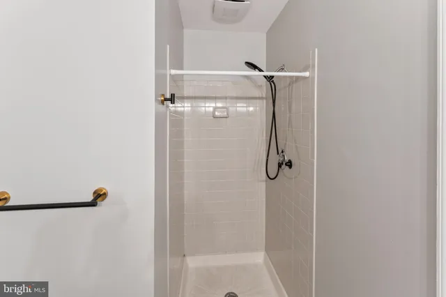 a view of a brick house with many windows next to a yard