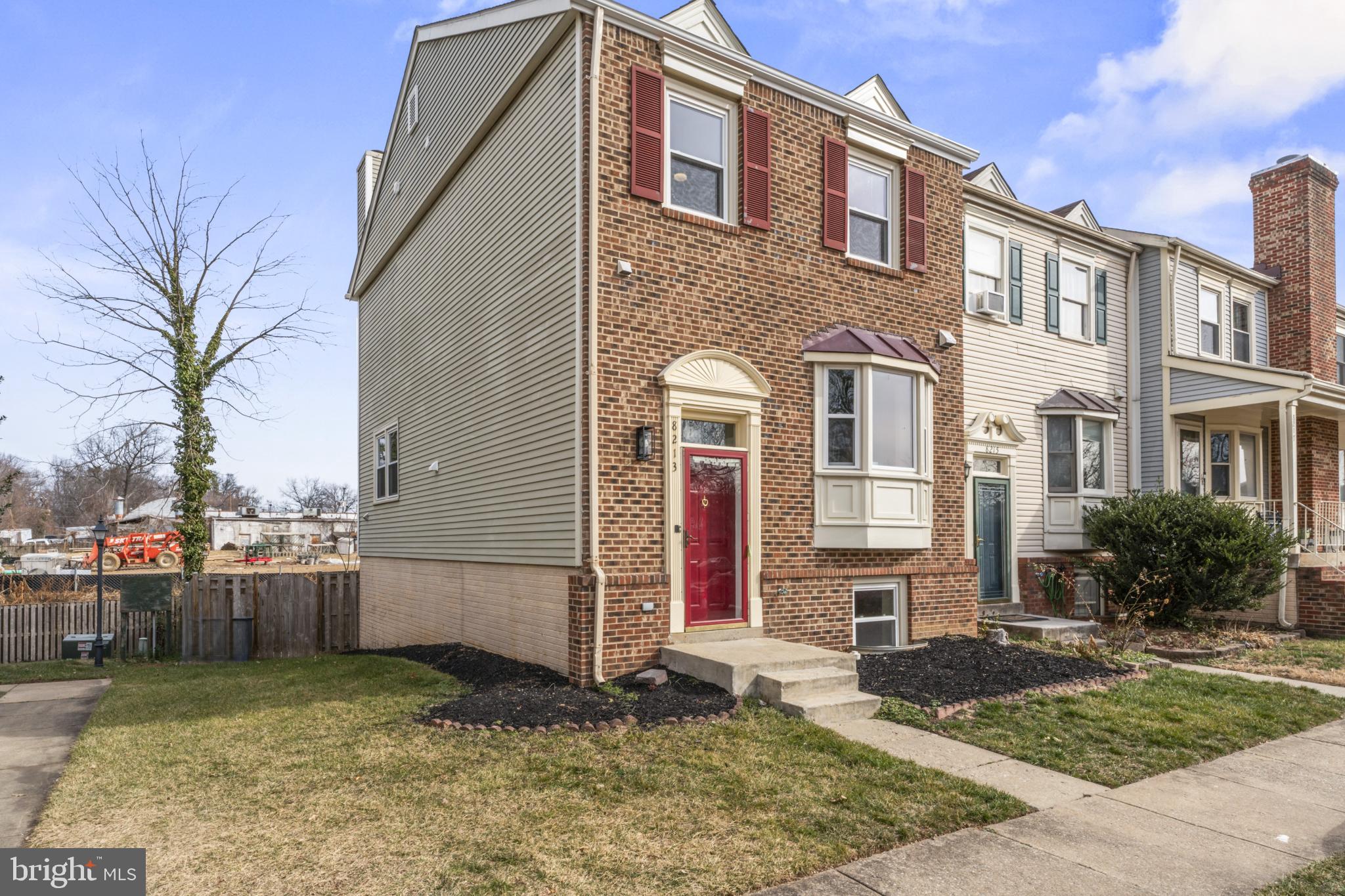 8213 Roxbury Drive Alexandria, VA 22309 - Photo 32 of 32 a view of a brick house with many windows next to a yard