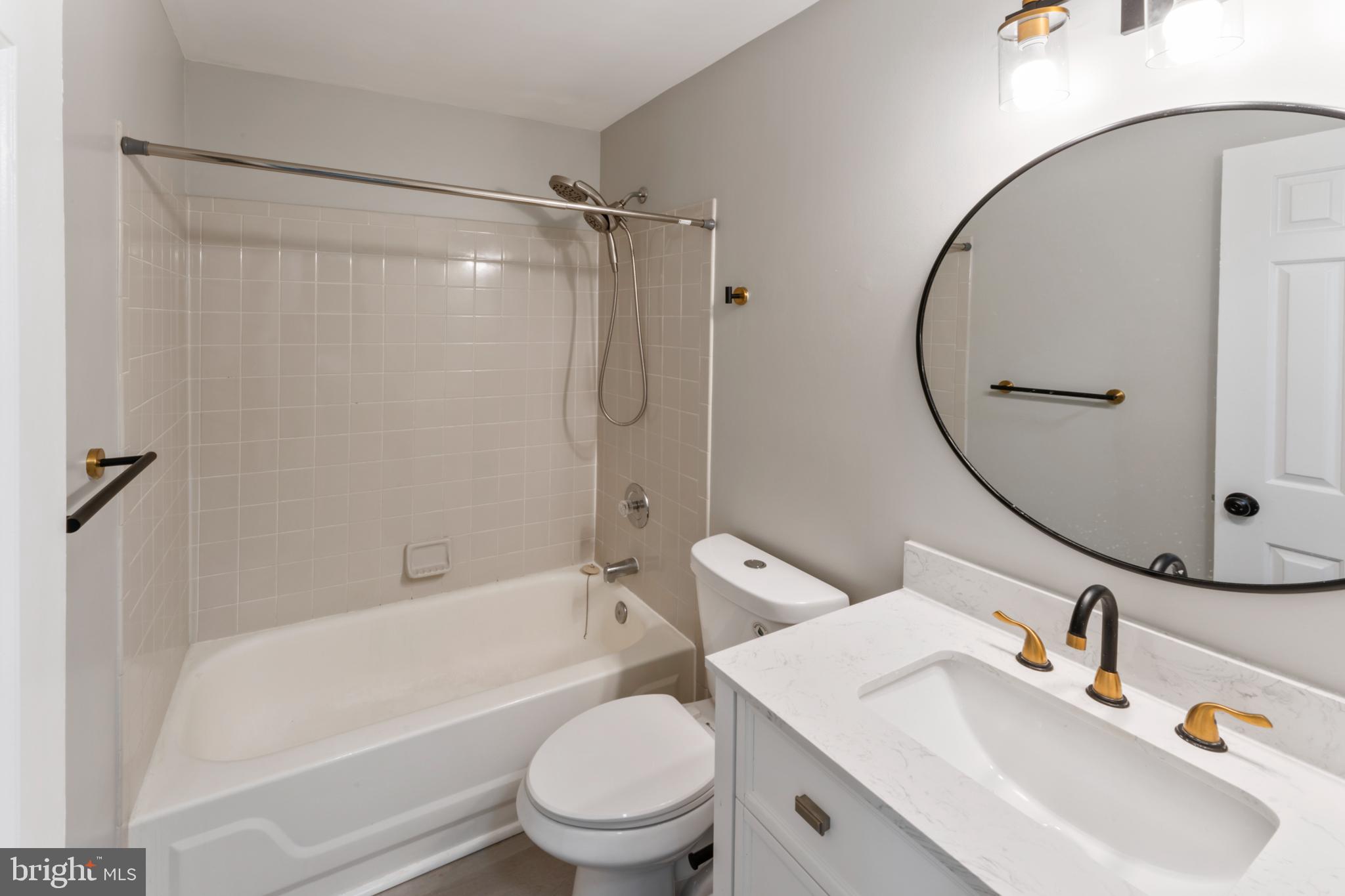 8213 Roxbury Drive Alexandria, VA 22309 - Photo 8 of 32 a bathroom with a sink toilet and shower