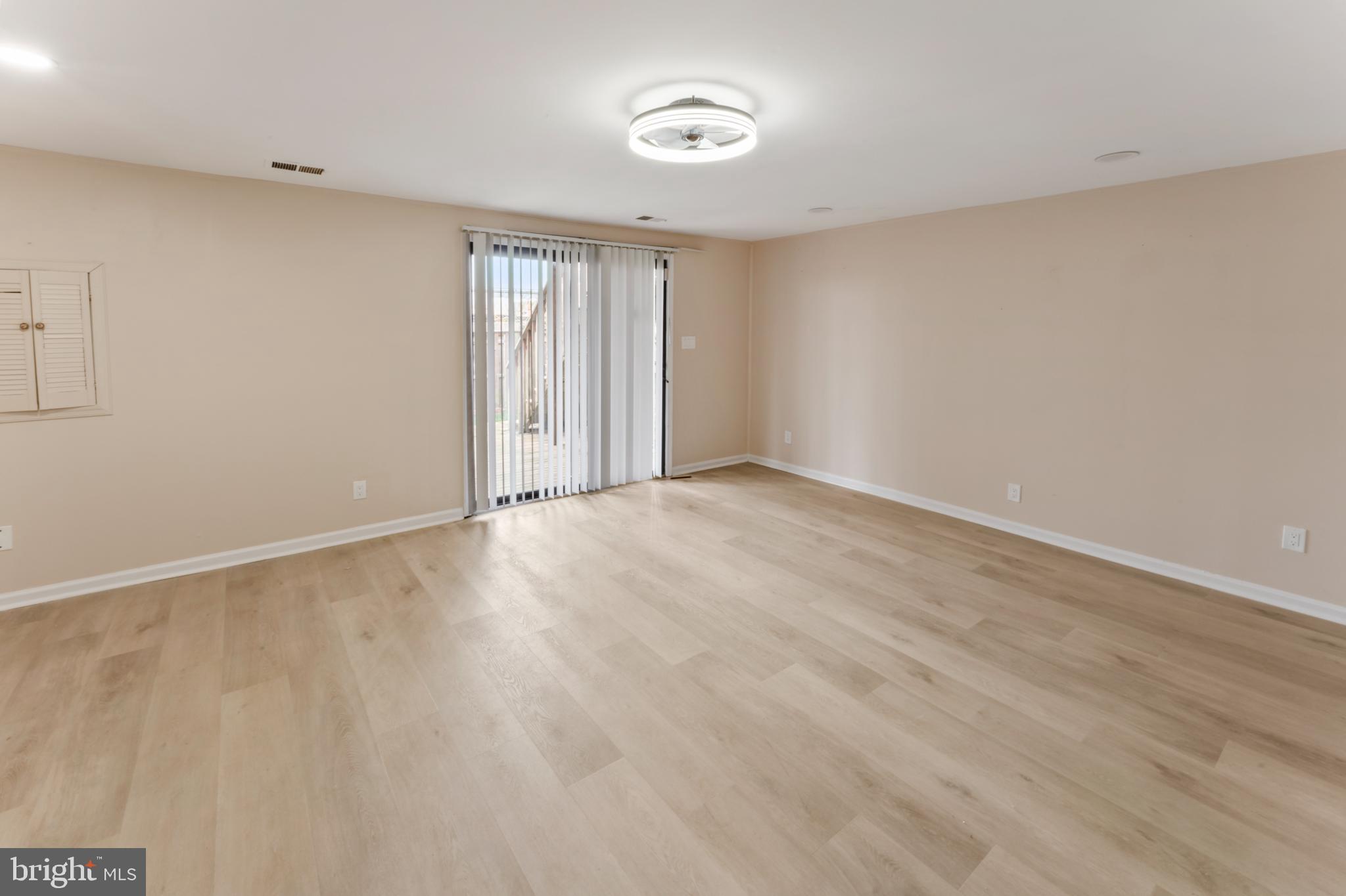 8213 Roxbury Drive Alexandria, VA 22309 - Photo 9 of 32 a view of an empty room with wooden floor and a window