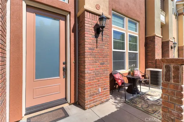 a view of a door of a house with outdoor seating