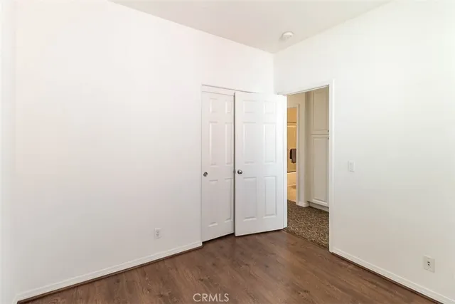 a view of a room with wooden floors