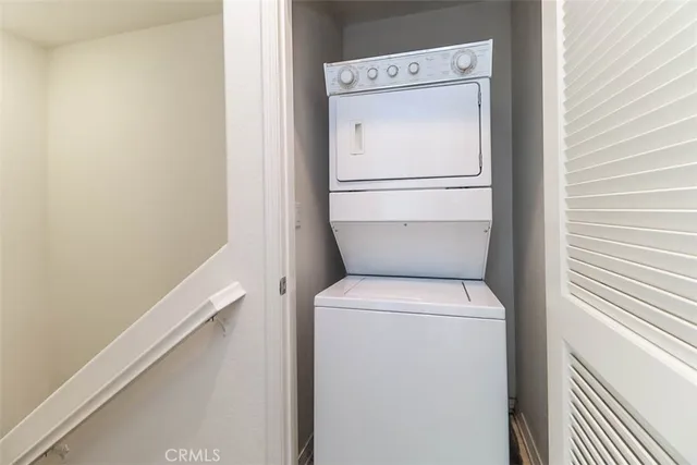 a view of a backyard with lawn chairs and plants