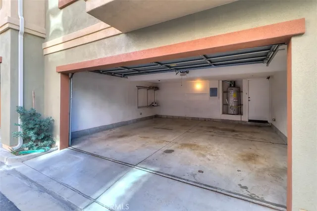 a view of a patio with a table and chairs under an umbrella