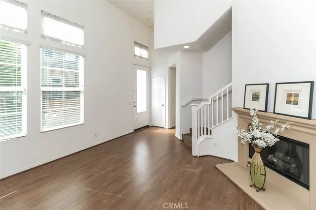 a view of a room that has wooden floor and a window