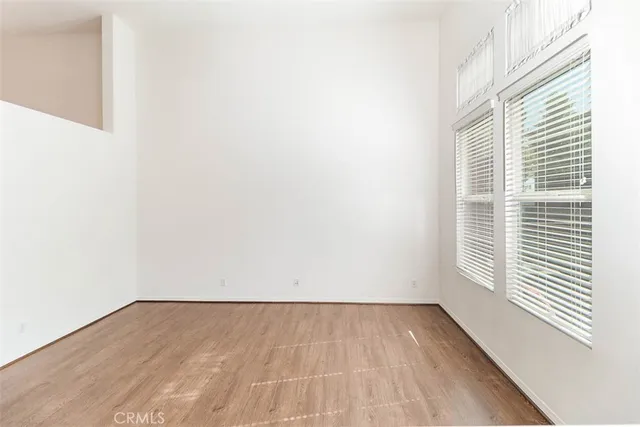 a kitchen with a white cabinets and chandelier