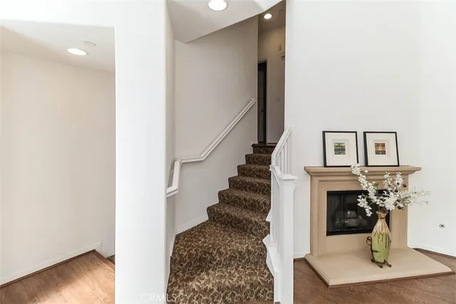 a view of a room with wooden floor and a chandelier
