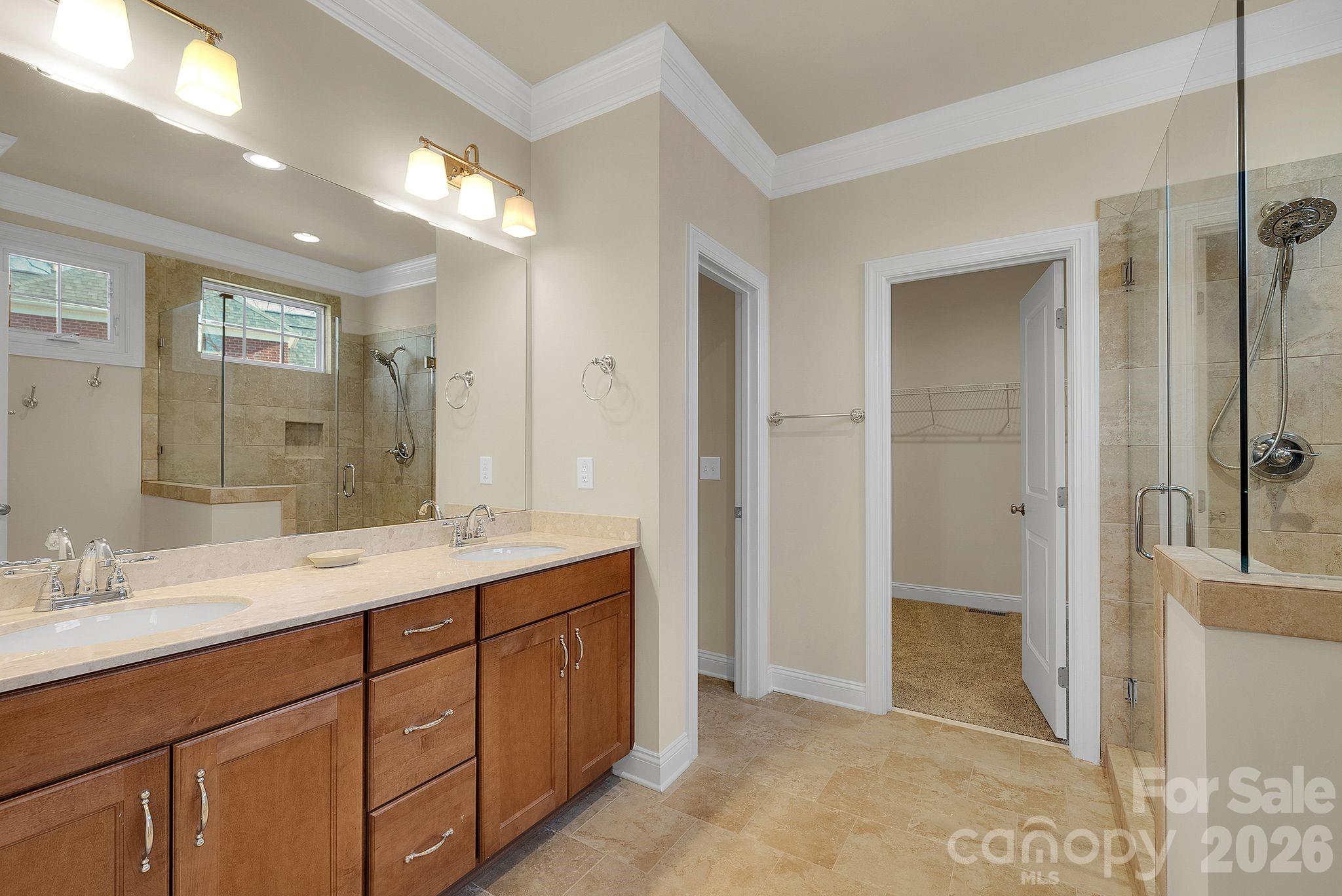 535 Brightleaf Place Northwest Concord, NC 28027 - Photo 21 of 48 a spacious bathroom with a shower sink and mirror
