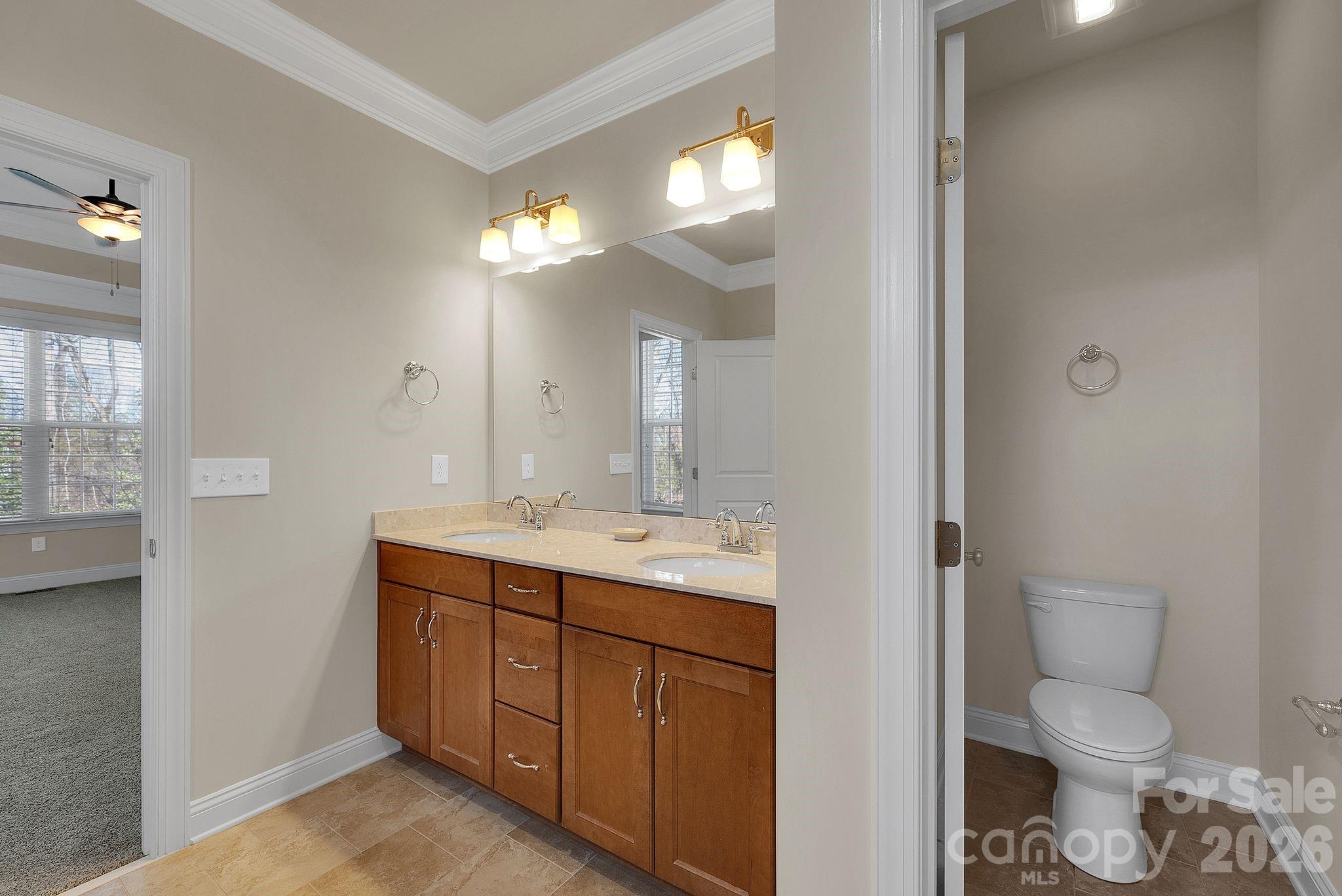 535 Brightleaf Place Northwest Concord, NC 28027 - Photo 22 of 48 a bathroom with a toilet a sink and a large mirror