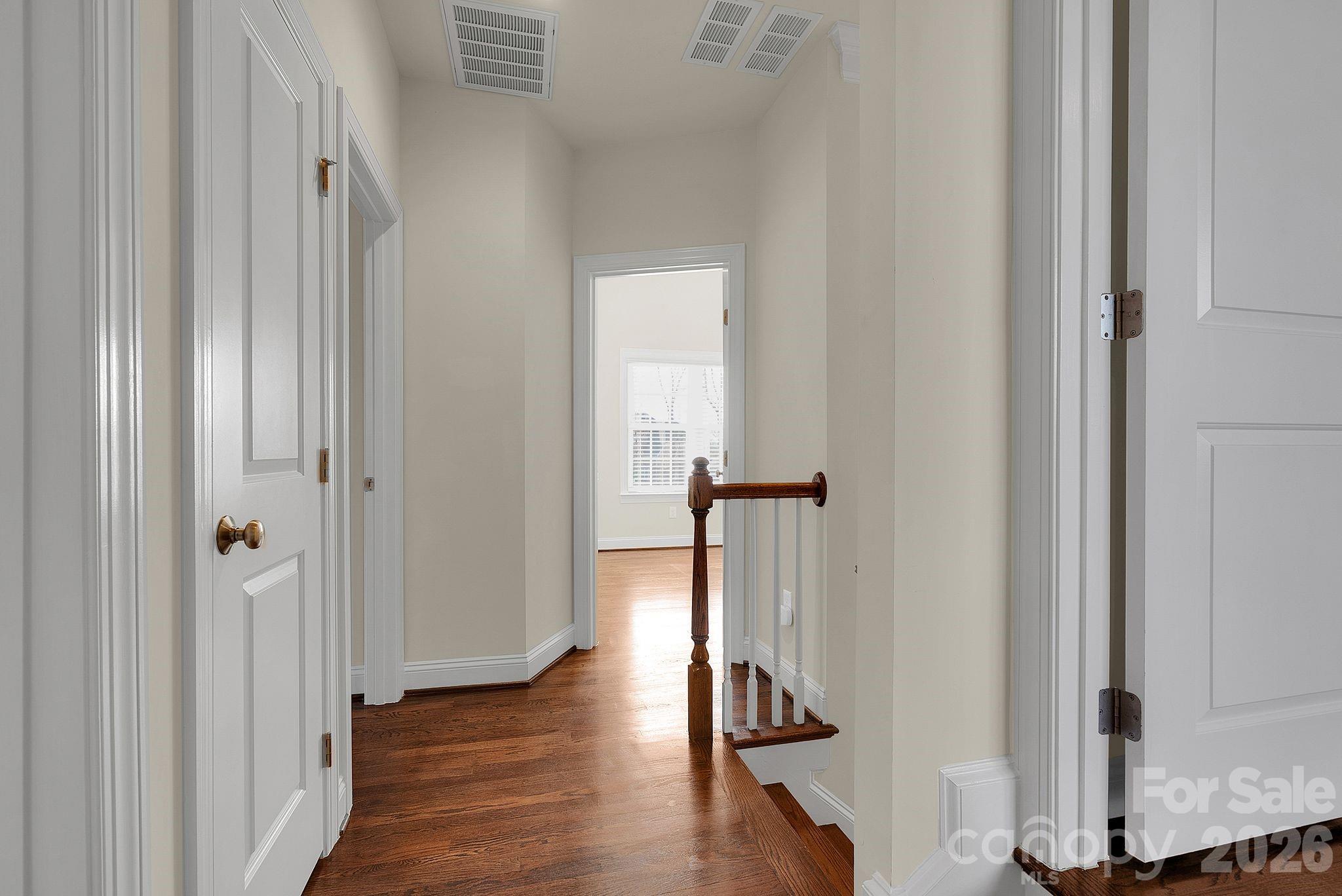 535 Brightleaf Place Northwest Concord, NC 28027 - Photo 25 of 48 a view of a hallway with wooden floor and staircase