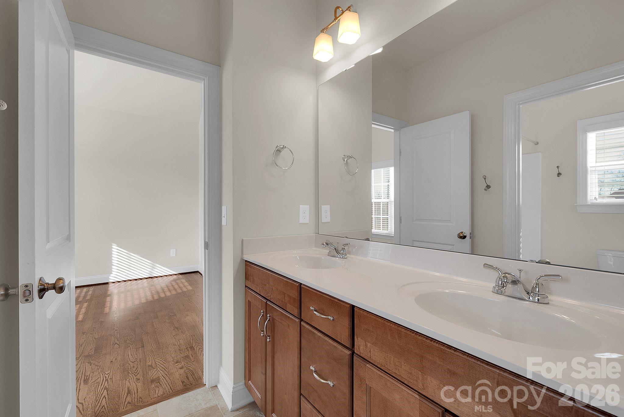 535 Brightleaf Place Northwest Concord, NC 28027 - Photo 27 of 48 a bathroom with a double vanity sink and a mirror