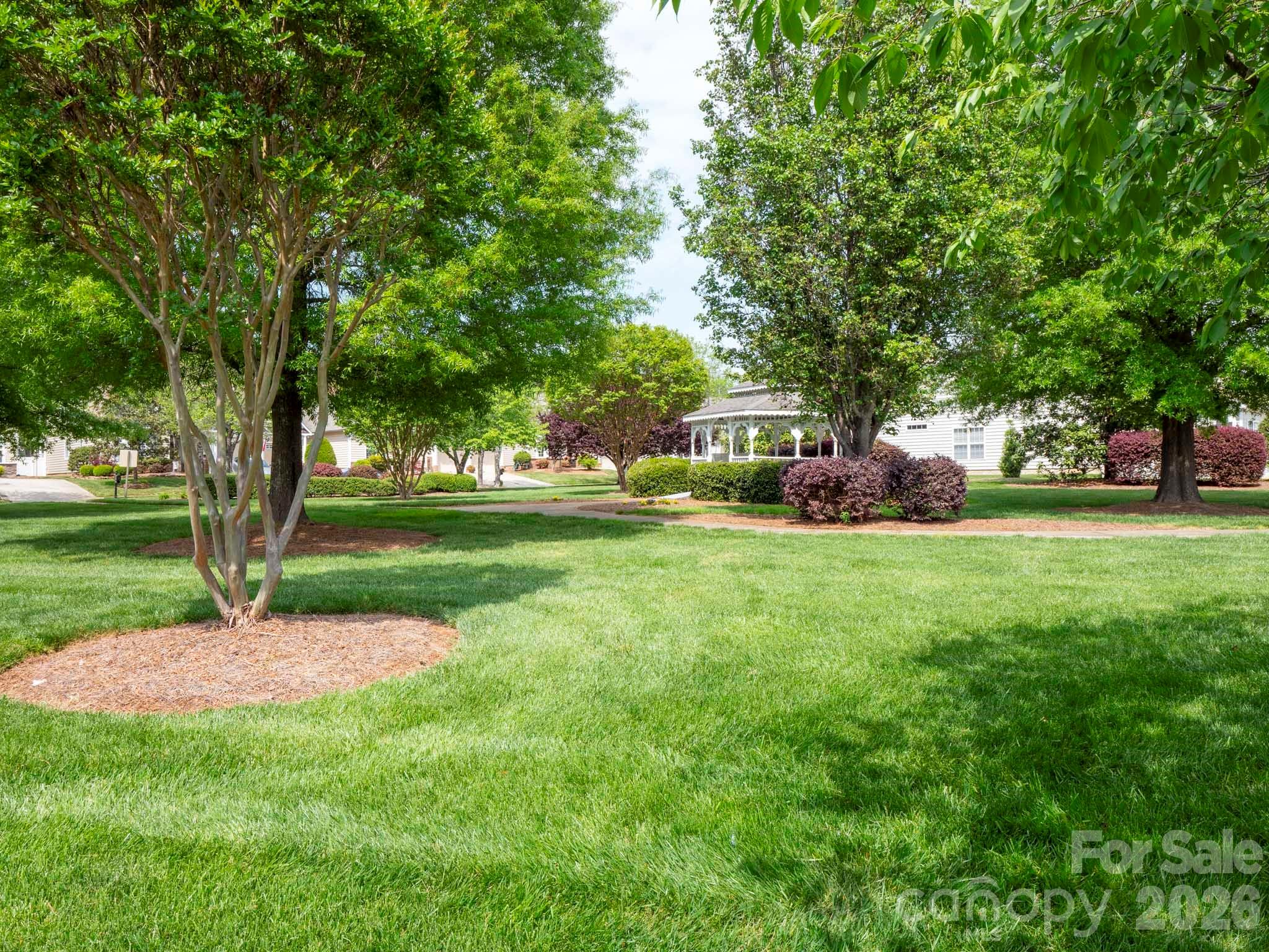 535 Brightleaf Place Northwest Concord, NC 28027 - Photo 47 of 48 a view of a backyard with a garden and trees