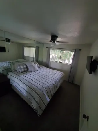 a bedroom with a large bed and a window