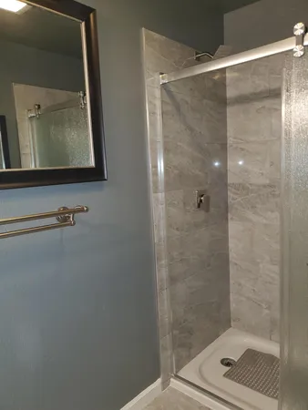 a bathroom with a shower and a mirror