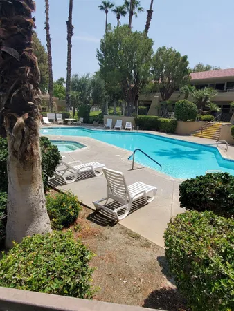 a view of a swimming pool with a yard