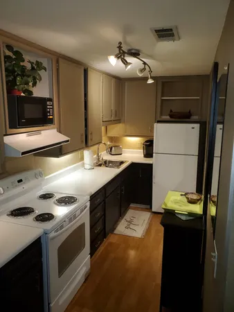 a kitchen with a stove and a refrigerator