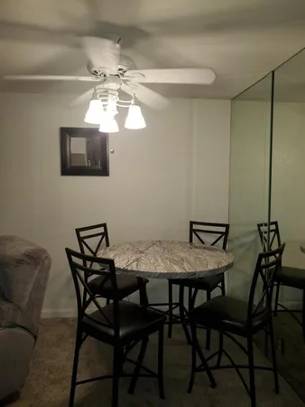 a view of a dining room with furniture and a chandelier