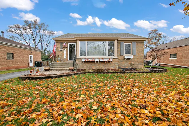 a view of a house with a yard and sitting area