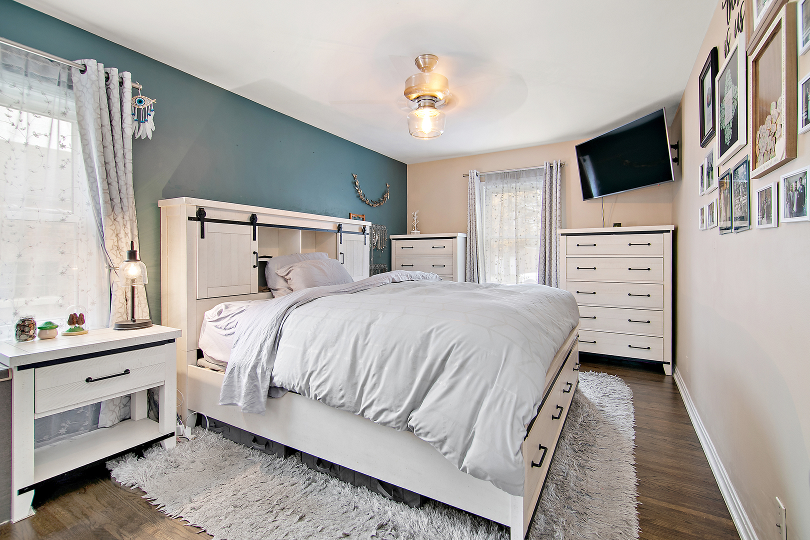 18524 Gottschalk Avenue Homewood, IL 60430 - Photo 13 of 28 a bedroom with a bed a flat tv screen and a dresser