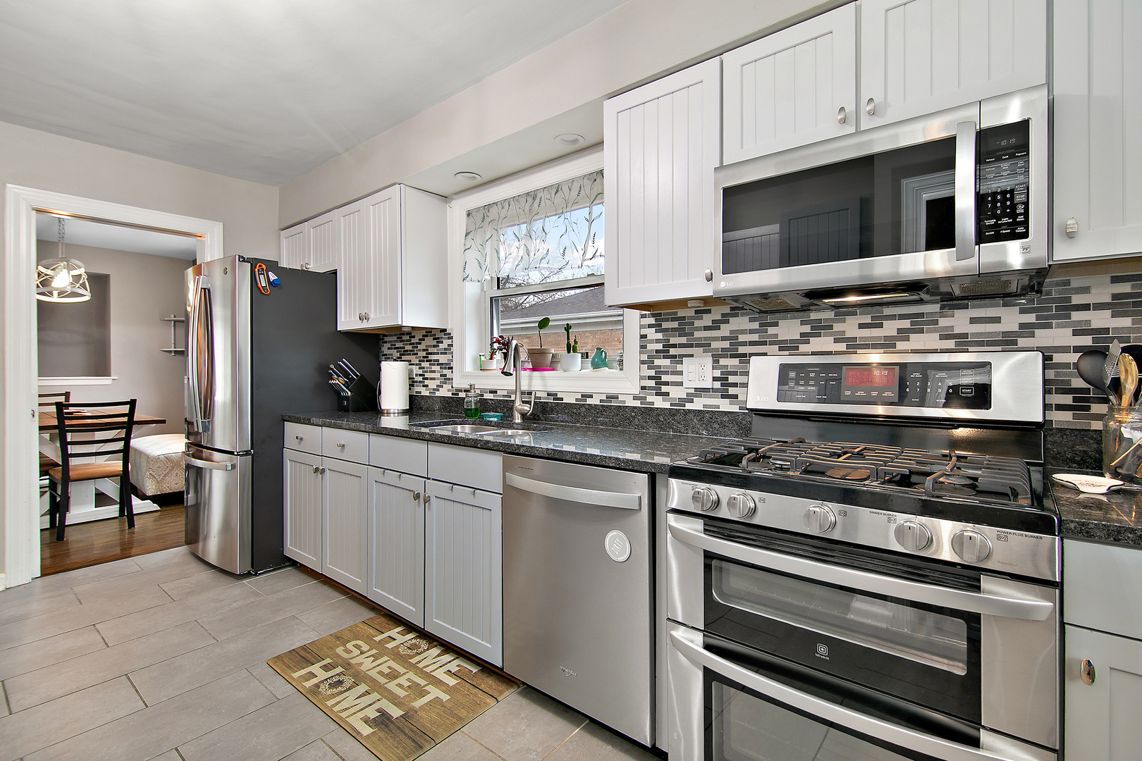 18524 Gottschalk Avenue Homewood, IL 60430 - Photo 9 of 28 a kitchen with stainless steel appliances a stove a sink and a microwave