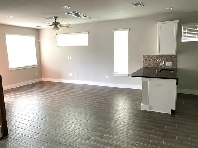 a front view of a house with garden and seating area